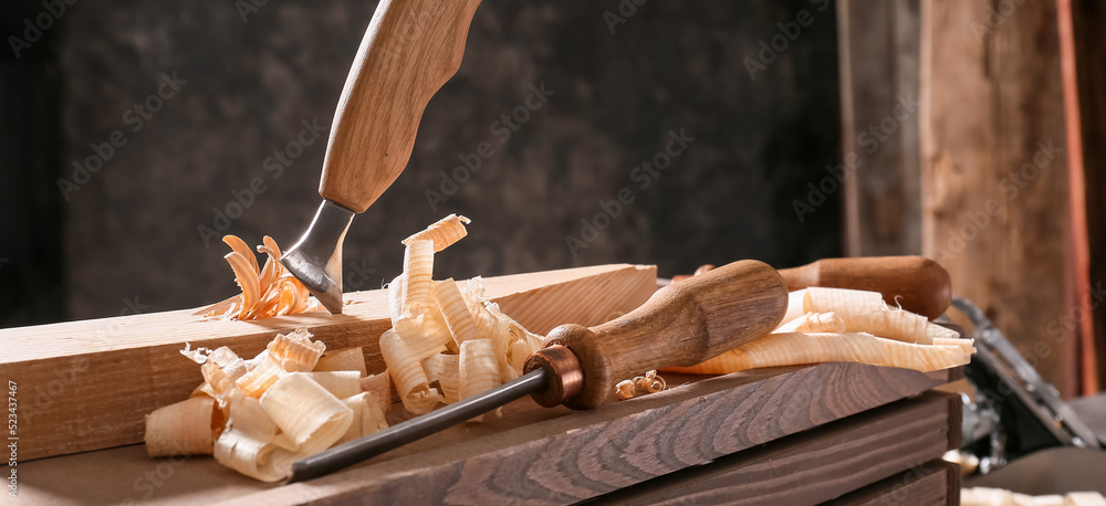 Wall mural carpenter's chisels on wooden box in workshop