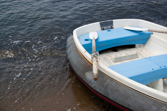 Empty inflatable boat with oars