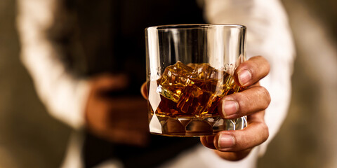 Barman pouring wiskey whiskey glass and giving.