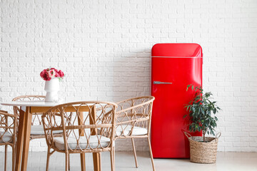 Stylish retro fridge in interior of dining room