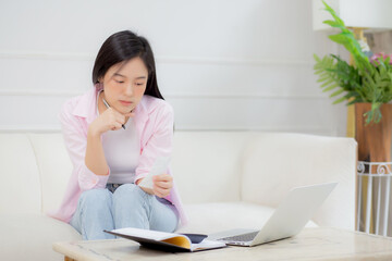 Young asian woman calculating expenses household about finance and frustrated at home, girl checking bill having stress and worried, debt and tax, expression and emotion tired, business concept.