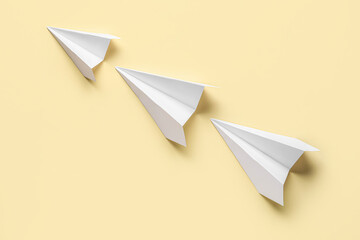 Paper planes on yellow background