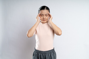 Asian woman was sick with headache standing isolated on white background.