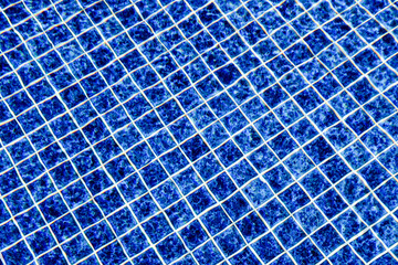 abstract background. swimming pool base. blue tiles on the bottom of a pool full of water