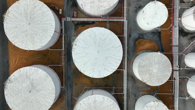 Top down aerial of huge bulk fuel storage tanks for oil, gas, home heating oil.