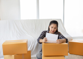 Young business woman working online shopping at her home