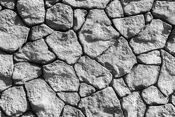 Closeup view of surface of rough stone wall.