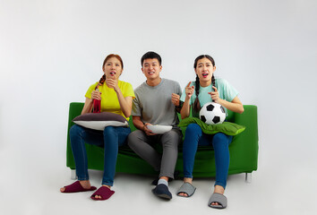 Happy friends asian football fans watching soccer on tv at home. Friendship, sports and...