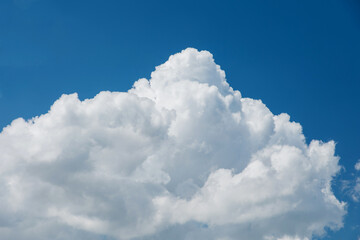 Naklejka na ściany i meble Closeup cumulonimbus clouds in summer with blue sky