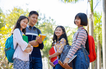 Group of happy teenagers having fun in park after school, education concept