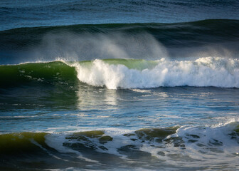 Breaking wave with wind blown spray