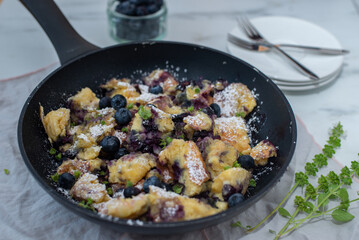 Kaiserschmarrn - traditional austrian pancake dessert with blueberries