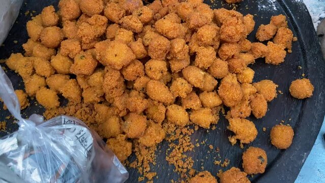 Extreme close up shot of moong dal pakora being served in a big wooden plate for sale in Kolkata, India