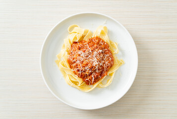 pork bolognese fettuccine pasta with parmesan cheese