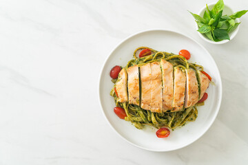 fettuccine spaghetti pasta in pesto sauce with grilled chicken