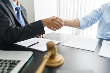 Lawyer and legal concept, Businessman and senior lawyer shake hands after successful deal contract