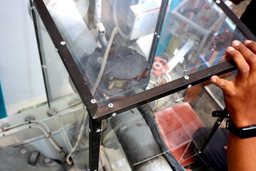 Jakarta, 24 June 2022; Installation of Acrylic transformer mechanical relay cover to prevent faults caused by short circuits due to rain water - obrazy, fototapety, plakaty