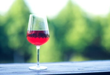 a glass of red wine on the table on a blurred background