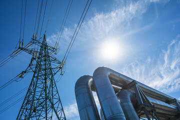 Industrial pipelines on pipe-bridge against blue sky