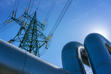 Industrial pipelines on pipe-bridge against blue sky