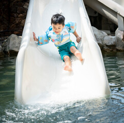Asian boy play on the  slider water