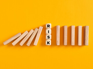 To stop the domino risk effect or risk prevention in business concept.