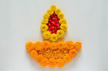Decorative marigold flowers and rose petals rangoli for Diwali festival on white background.