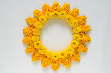 Decorative yellow and orange color marigold flowers and petals rangoli for Diwali festival with white space background.