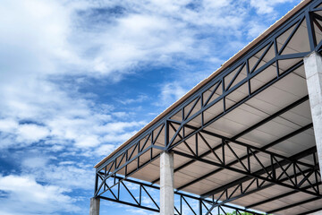 White PU foam metal roof on black steel structure in construction site.