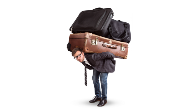 Man carrying a lot of heavy luggage on his back