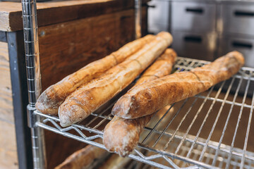 Fresh tasty Baguettes on bakery shelves. Concept of french delicious food. Delicious loaves of bread in baker shop. Food banner
