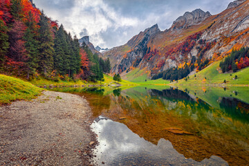 Incredible autumn scene of Swiss Alps with Santis peak reflected in calm waters of Seealpsee lake. Amazing outdoor scene of Switzerland countryside. Beauty of nature concept background.