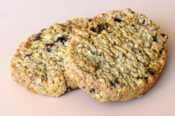 two soft flaky cookies on an orange background
