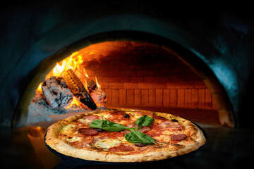 Delicious Italian pizza in a shovel putting in wood burning oven
