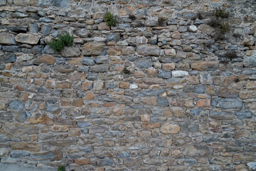 Stone facade old wall vintage texture panoramic background siding different sized stones