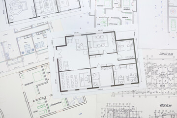 Technological drawings of buildings on large white sheets of paper.