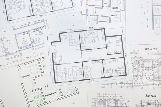 Technological drawings of buildings on large white sheets of paper.
