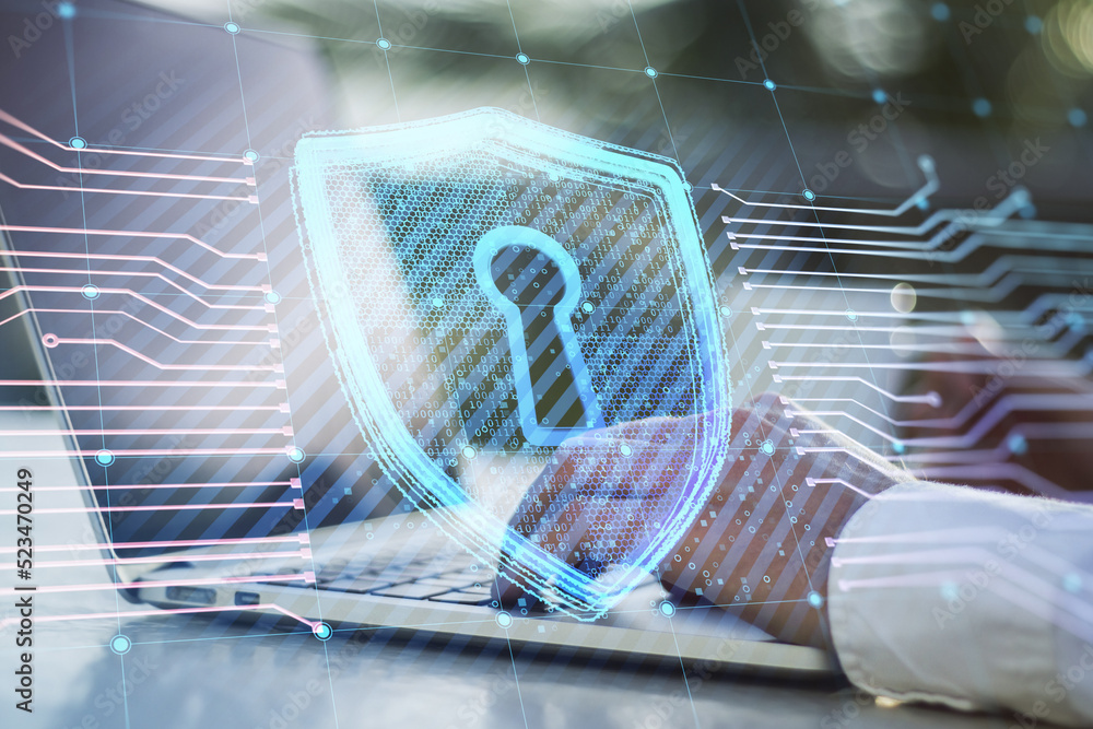 Poster close up of businessman hands using laptop on desktop with coffee cup and creative glowing shield ci