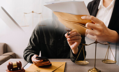 Male lawyer working with contract papers and wooden gavel on tabel in courtroom. justice and law ,attorney, court judge, concept.