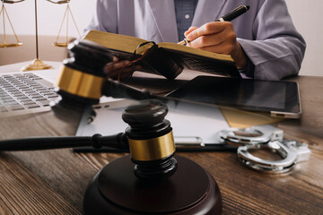 Male lawyer working with contract papers and wooden gavel on tabel in courtroom. justice and law ,attorney, court judge, concept.