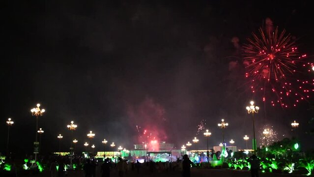 Slow Motion Colorful fireworks that explode and fill the darkness of the night sky with colored light at Parliament House of Pakistan