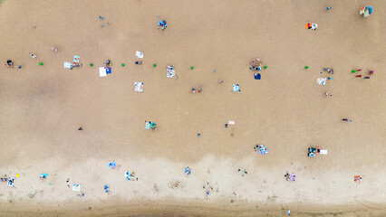 Drone view of the beach and people resting