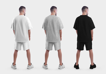 Oversized suit mockup, white, black, heather t-shirt, shorts on a guy in sneakers, back view,...
