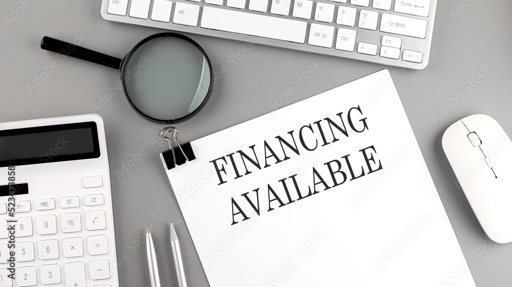 Poster financing available written on paper with office tools and keyboard on the grey background