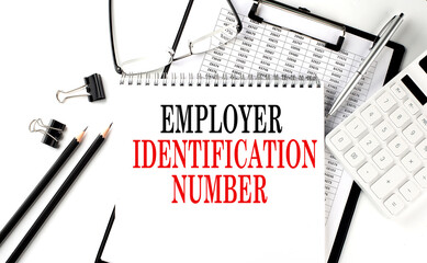 EIN - Employer Identification Number word on notepad with clipboard , chart and calculator, business concept