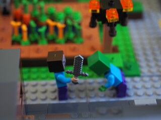 Fototapeta premium Elements and fragments of Lego village world set. Characters of electronic game Minecraft. Children's designer with small details, developing motor skills and imagination.