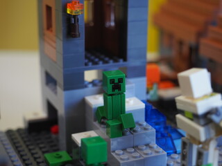 Fototapeta premium Elements and fragments of Lego village world set. Characters of electronic game Minecraft. Children's designer with small details, developing motor skills and imagination.