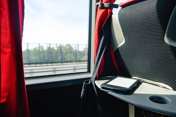 road trip travel concept electric book on the table in the bus