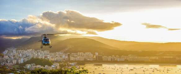 Rio de Janeiro, Brazil. Helipad with helicopter taking off from Urka mountain viewpoint on sunset. © Александра Замулина