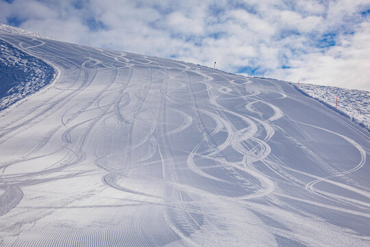 Skiing tracks under cloudy sky